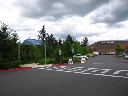 Trail entrance with crosswalk behind Cabela's store - entrance sign - bike rack Trail entrance with crosswalk behind Cabela's store - entrance sign - bike rack